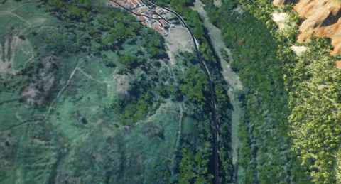 La route départementale serpente sous les feuillus